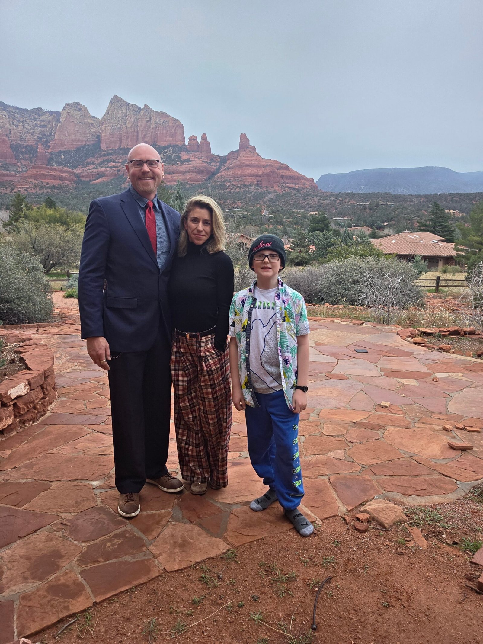 Dustin, Rachel, and Cyprus of Magic Movers US together in Sedona, Arizona, with the red rock mountains in the background.